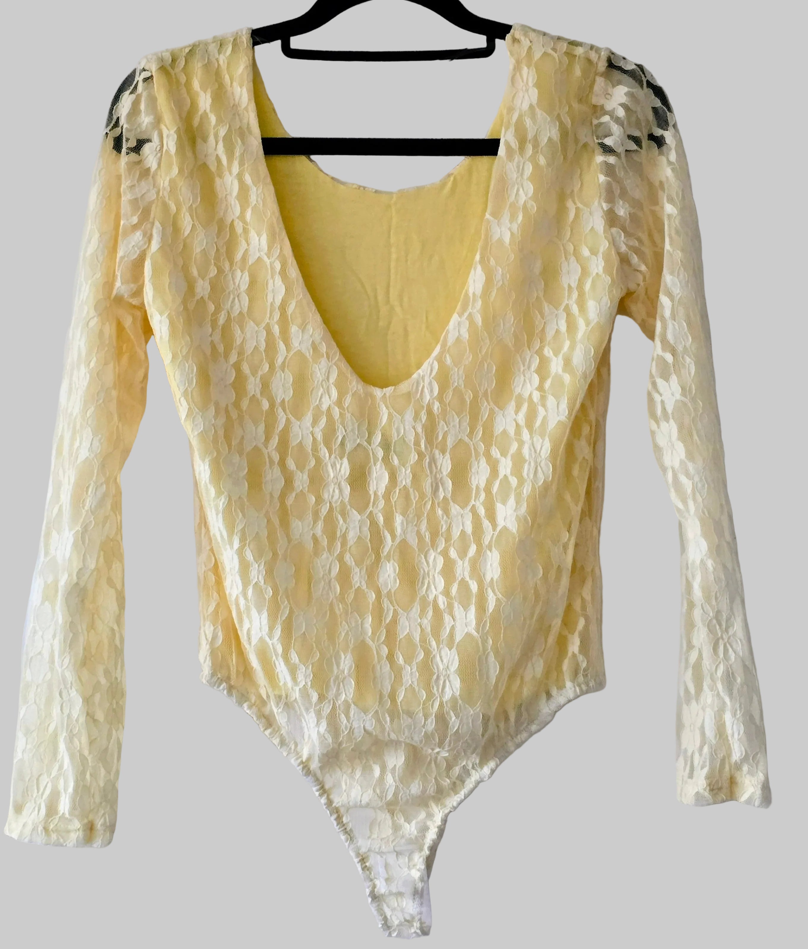 Women’s lace bodysuit in light yellow, long sleeves, V neckline, high-cut leg