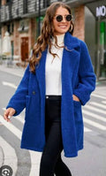 Blue lamb wool coat with button front, long sleeves, and side pockets