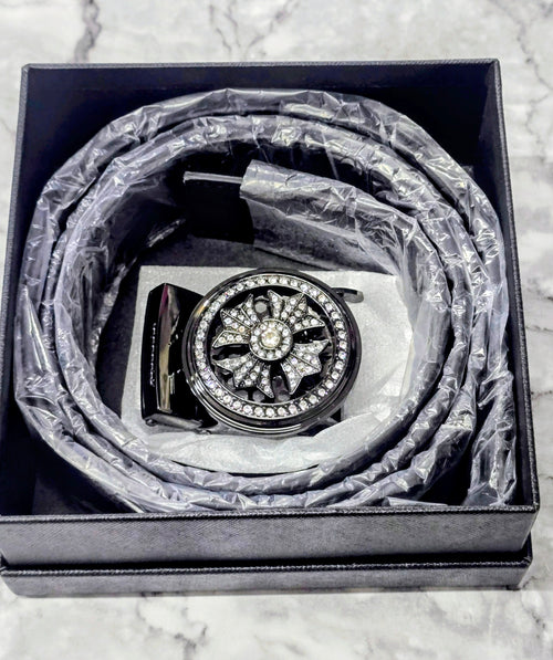 Men's black belt with ornate round rhinestone buckle, coiled in box