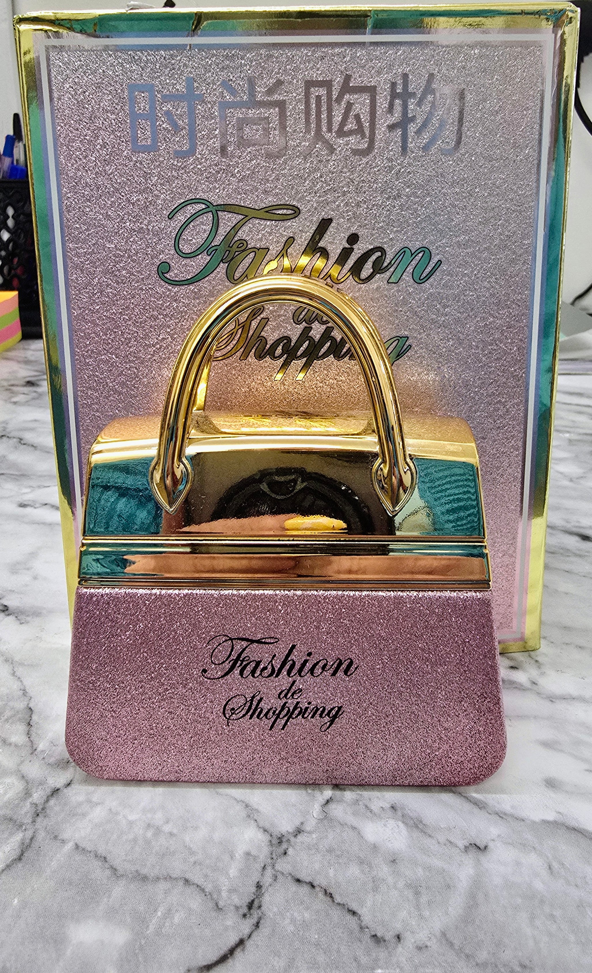 Women's perfume handbag box with gold handle, purple glitter front and Fashion Shopping logo