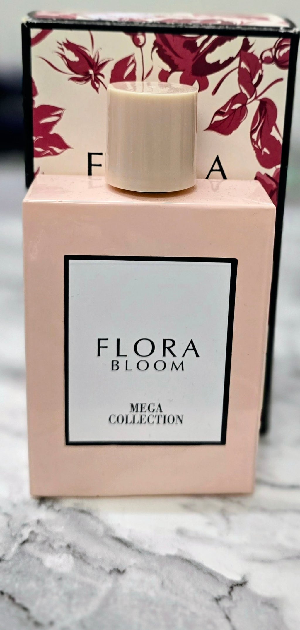 Flora Bloom perfume carton with white cap and burgundy floral background, Mega Collection