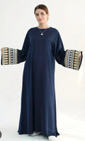 Dark blue abaya dress with wide sleeves and patterned embroidered cuff bands