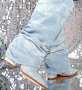 Light blue bootcut jeans with relaxed leg opening and back yoke seams.