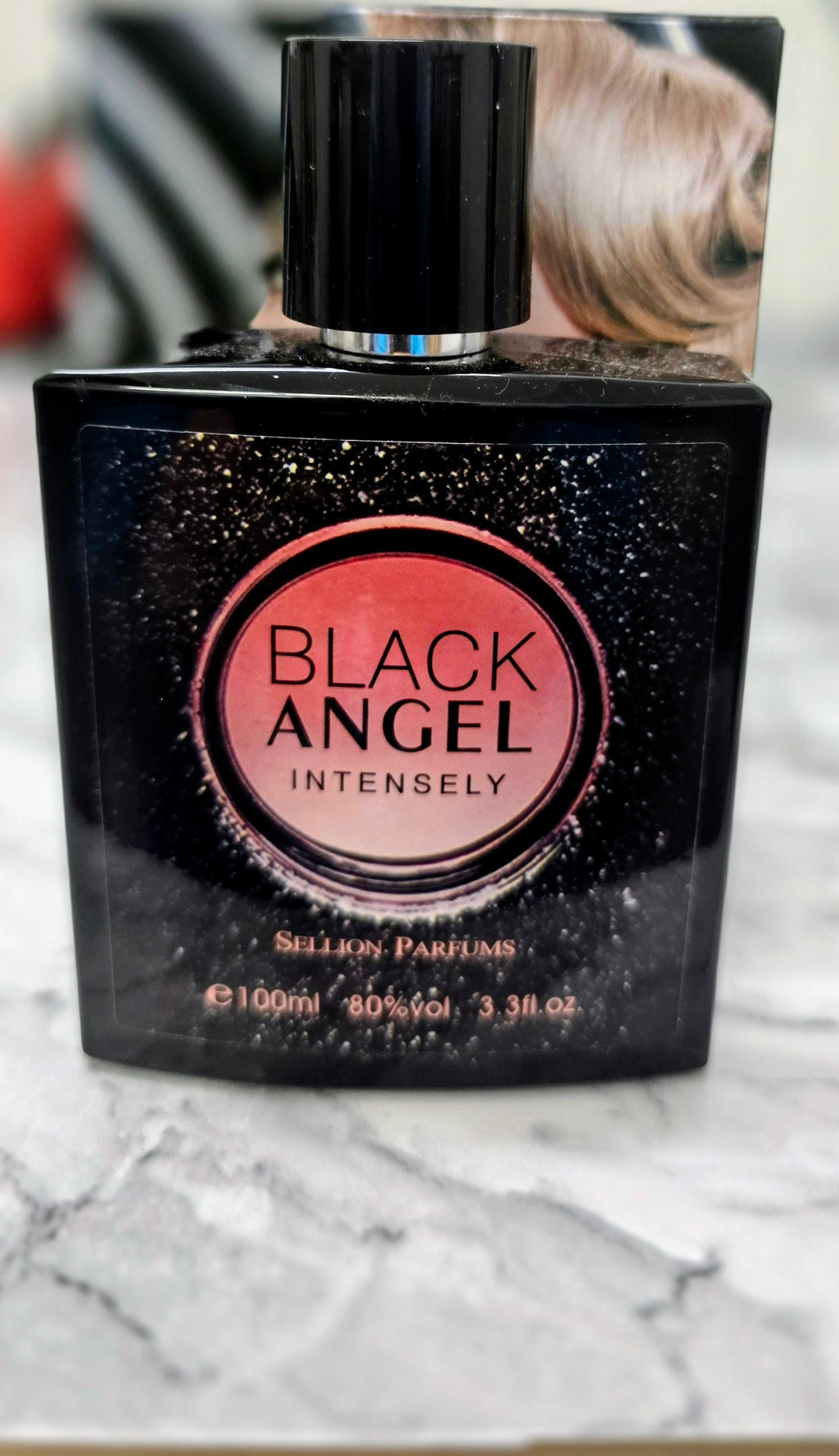 Women's perfume bottle with black label and rose-gold 'Black Angel' badge