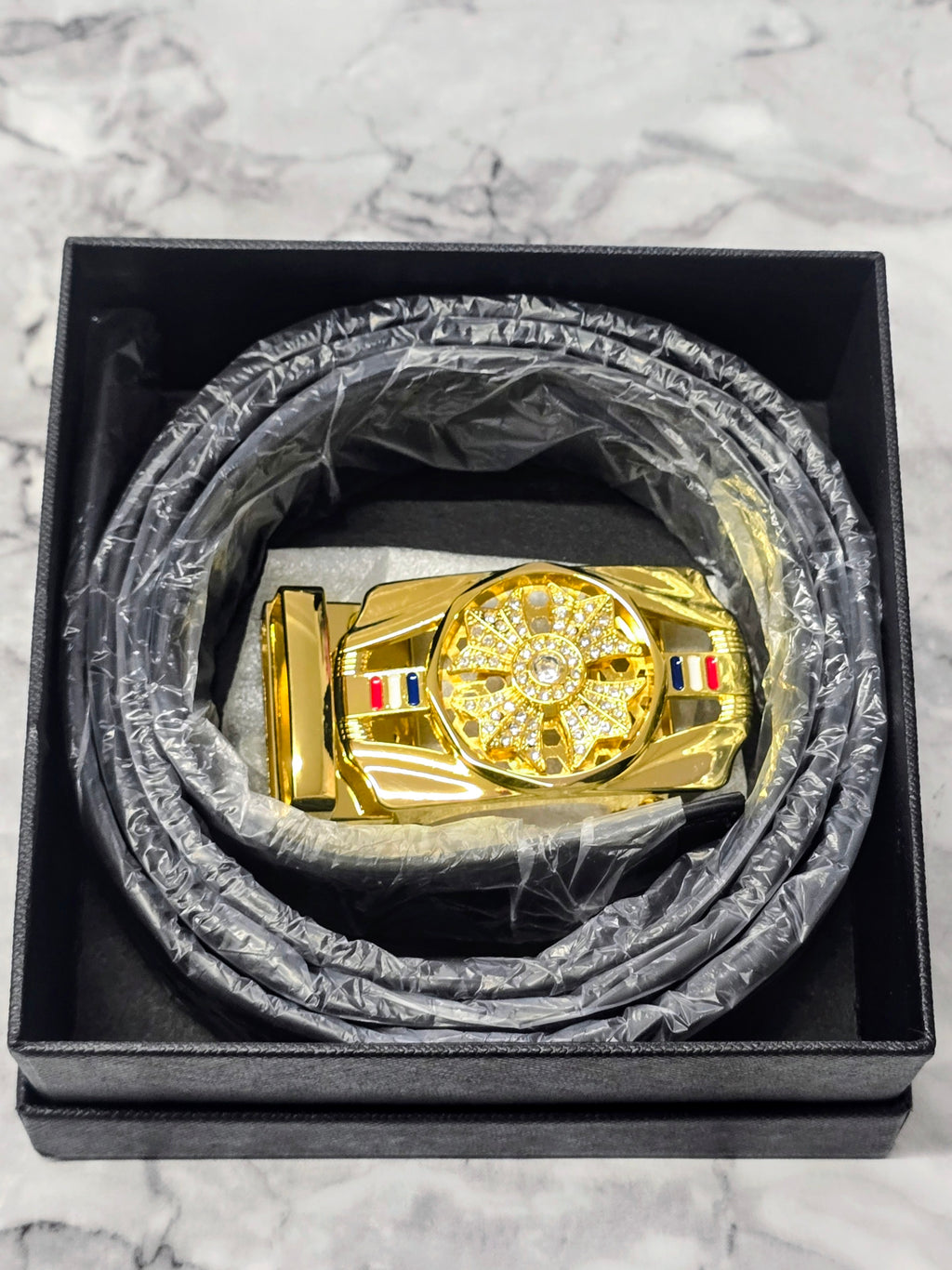 Coiled leather belt in gift box, dark strap with gold jeweled buckle