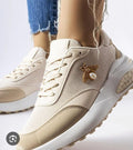 Beige bow-detail women's sneakers with lace-up front and embellished side charm