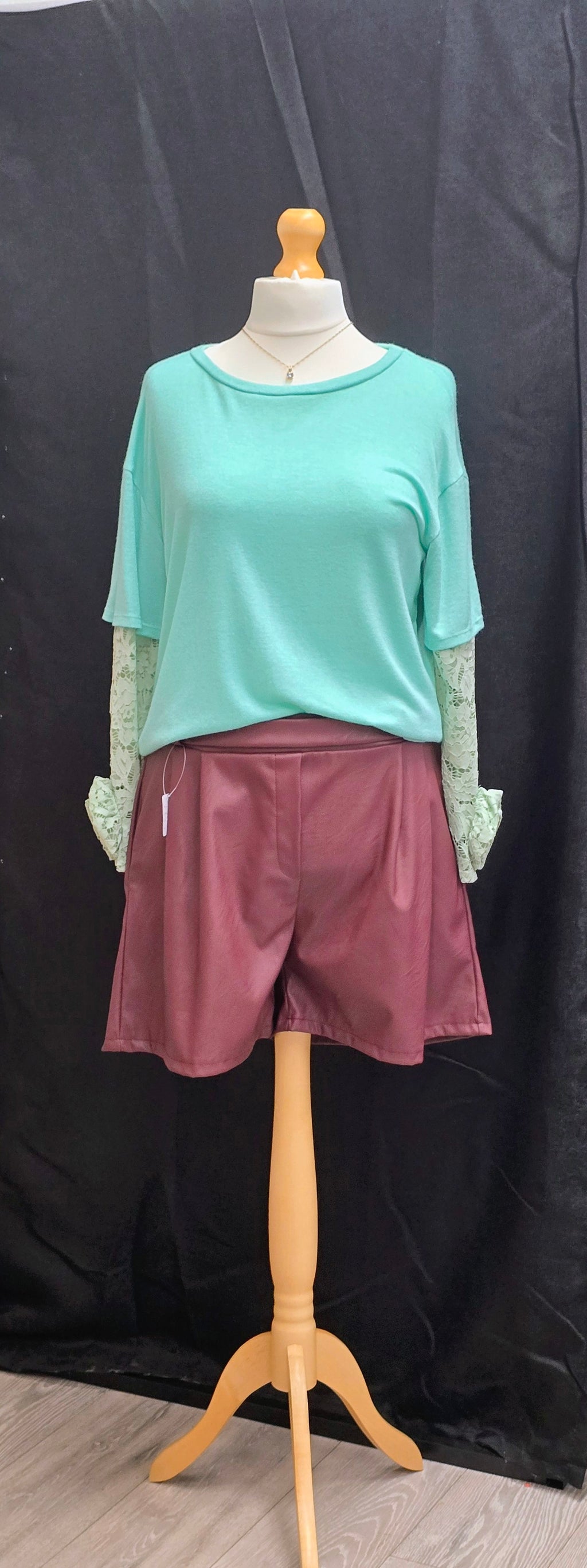 Teal green women's blouse with short sleeves and lace cuff trim