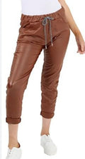 Brown faux leather trousers with ruched drawstring waist and cuffed hems