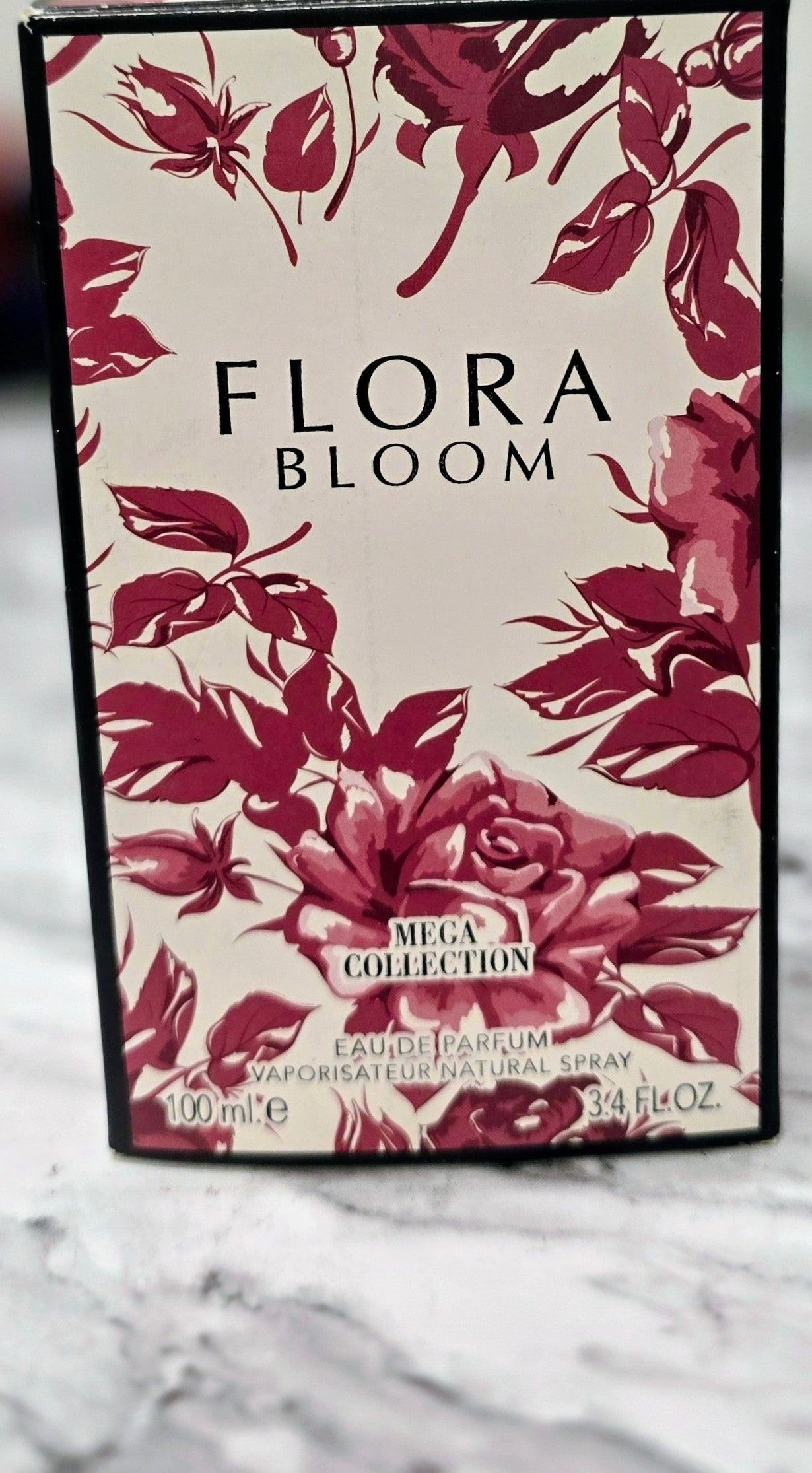 Flora Bloom eau de parfum bottle box with burgundy floral pattern, 100 ml label