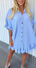 Light blue tunic with button front, ruffled sleeves, and tiered hem