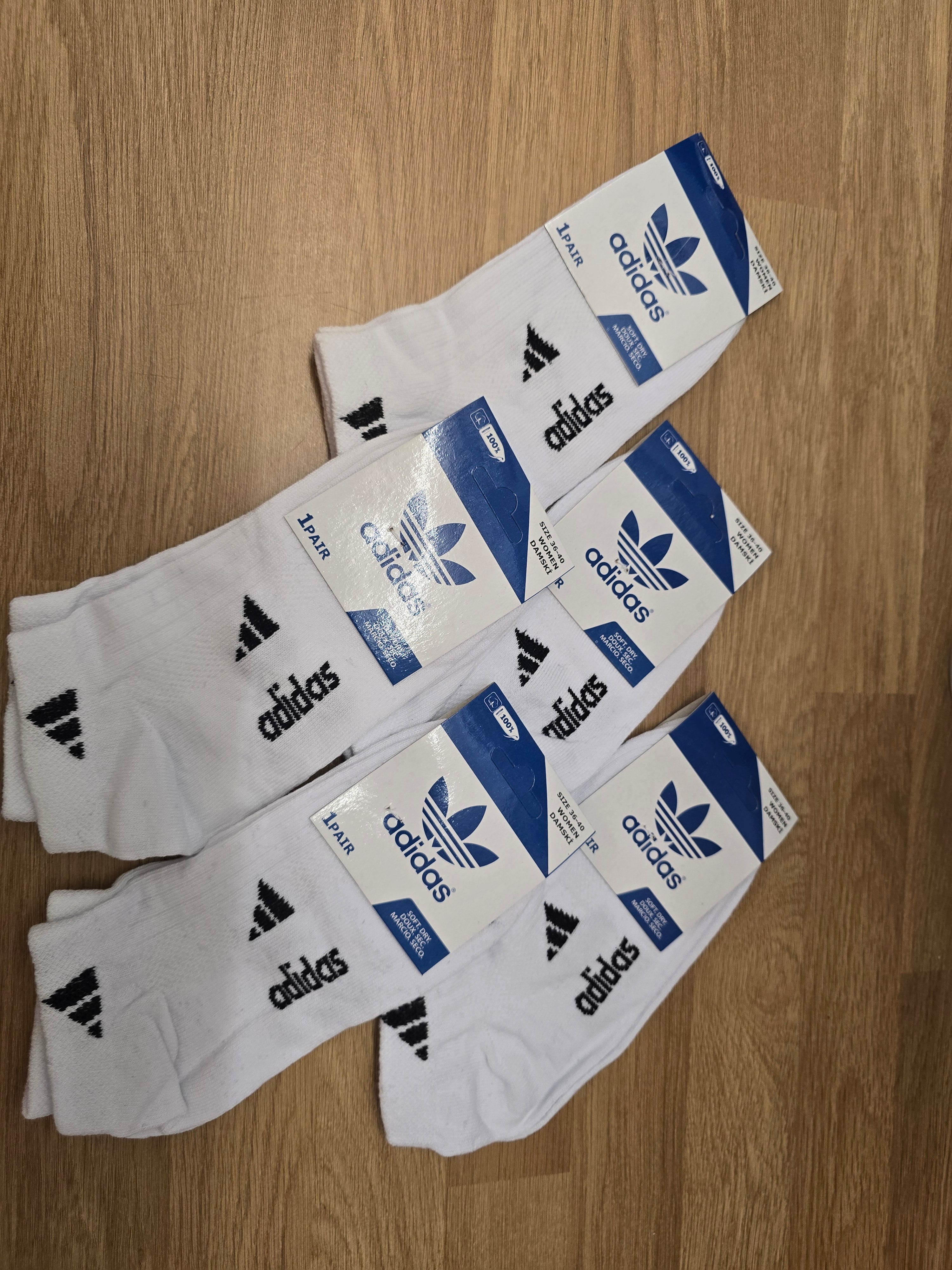 Women's white crew socks with black pattern and adidas logo