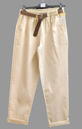 Beige women’s punto trousers with dark belt, cuffed hems and front pleats.