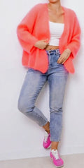 Short cardigan sweater in coral pink, open front, long sleeves