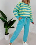 Women’s spring co-ord set with blue-green striped sweatshirt and matching drawstring joggers