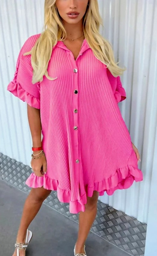Pink pleated tunic with collar, button front, short sleeves, and ruffled hem