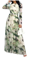 Women’s maxi dress with green floral print, long sleeves, cinched waist, full skirt