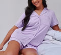 Women's satin pajama shirt and shorts set in light purple